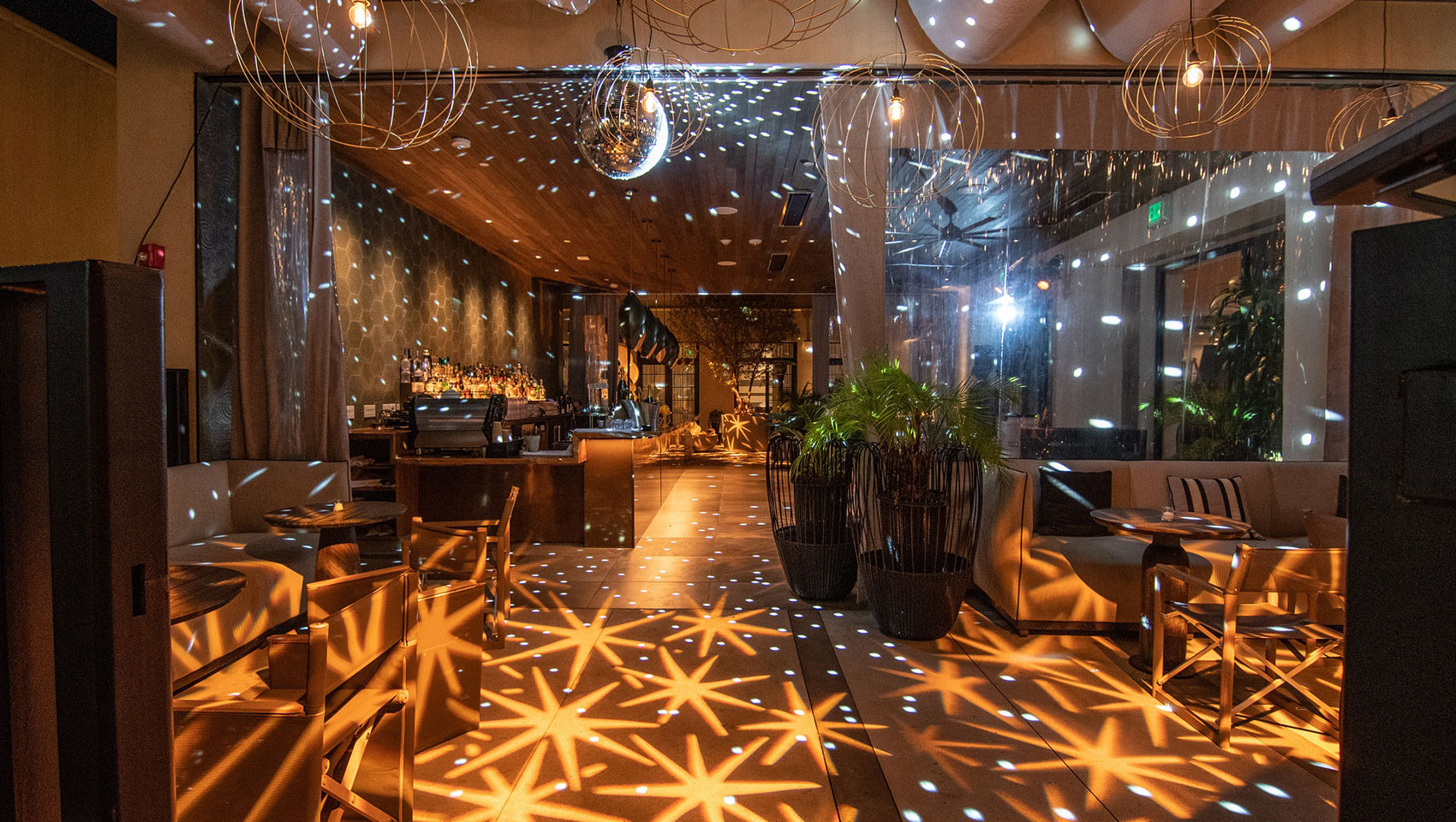 Nightime view of courtyard bar at Kimpton La Peer Hotel